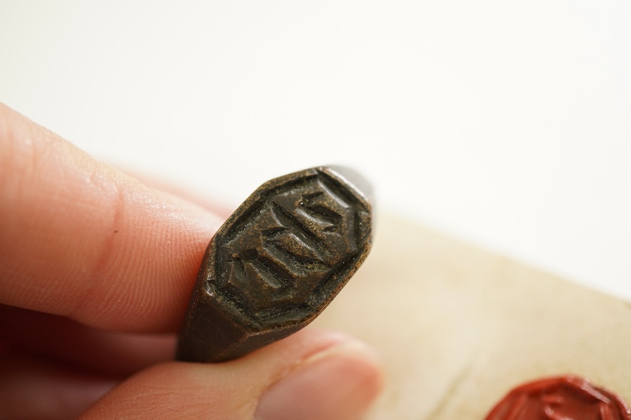 A bronze devotional signet ring, England, 16th/17th century, the octagonal panel inscribed with the Christogram IHC, to a plain bronze band, size S1/2, Provenance: formerly in the collection of Dame Joan Evans (1893-1977